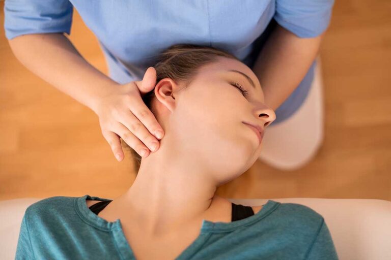 A person receiving a gentle spinal adjustment from a licensed professional in a calm clinical setting.